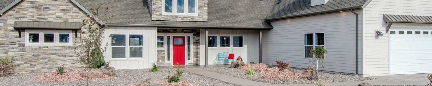 exterior of new home with oversized garage for RV parking, front entry with red door and second garage