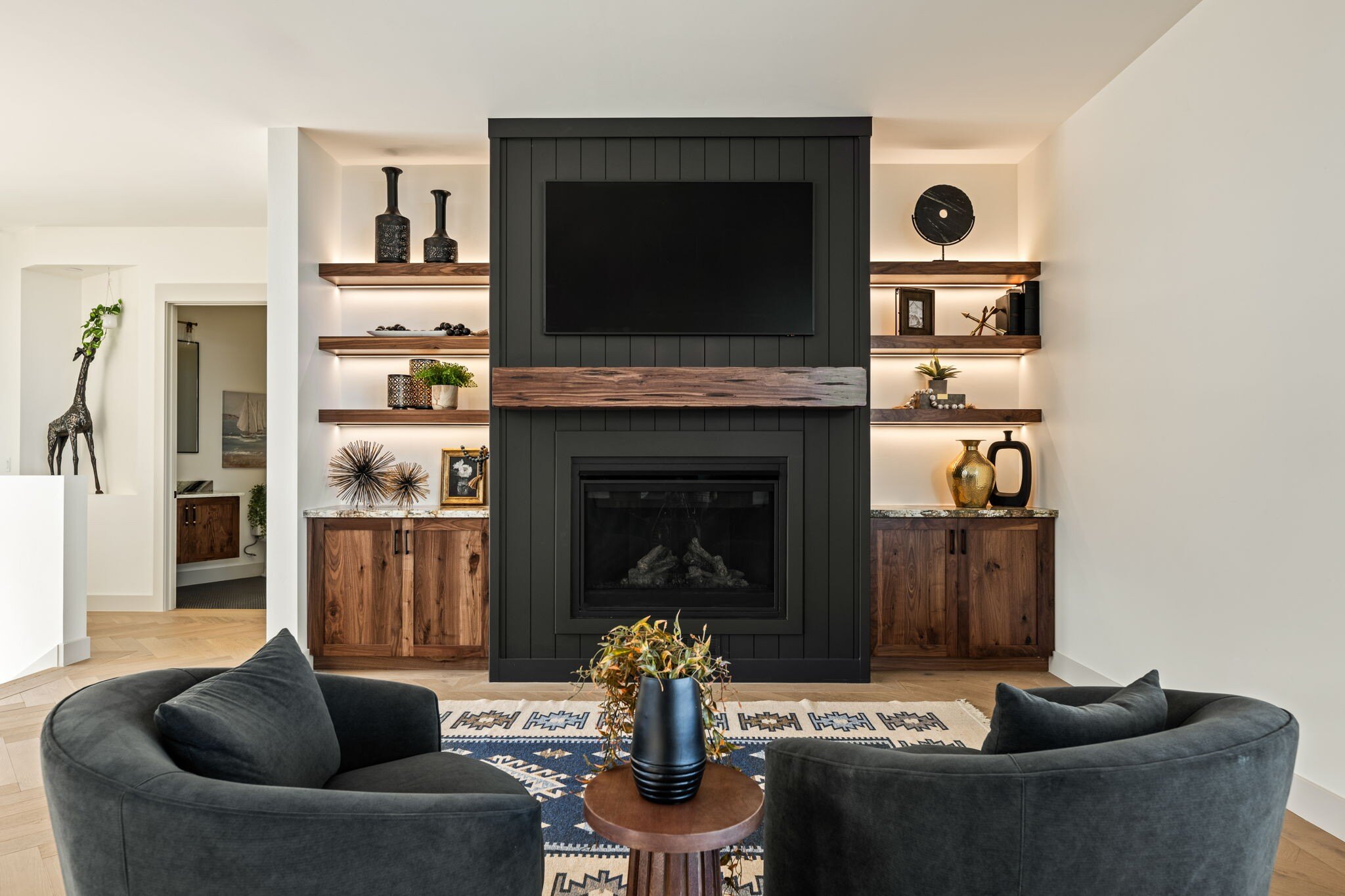 A cozy fireplace surrounded by custom shelving in a modern custom mountain lodge home in Brian Head, UT by Choice Builders.