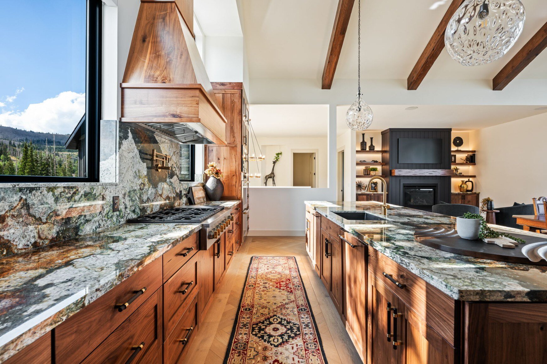 Bright and spacious kitchen with granite countertops and scenic views in a custom mountain lodge home in Brian Head, UT by Choice Builders