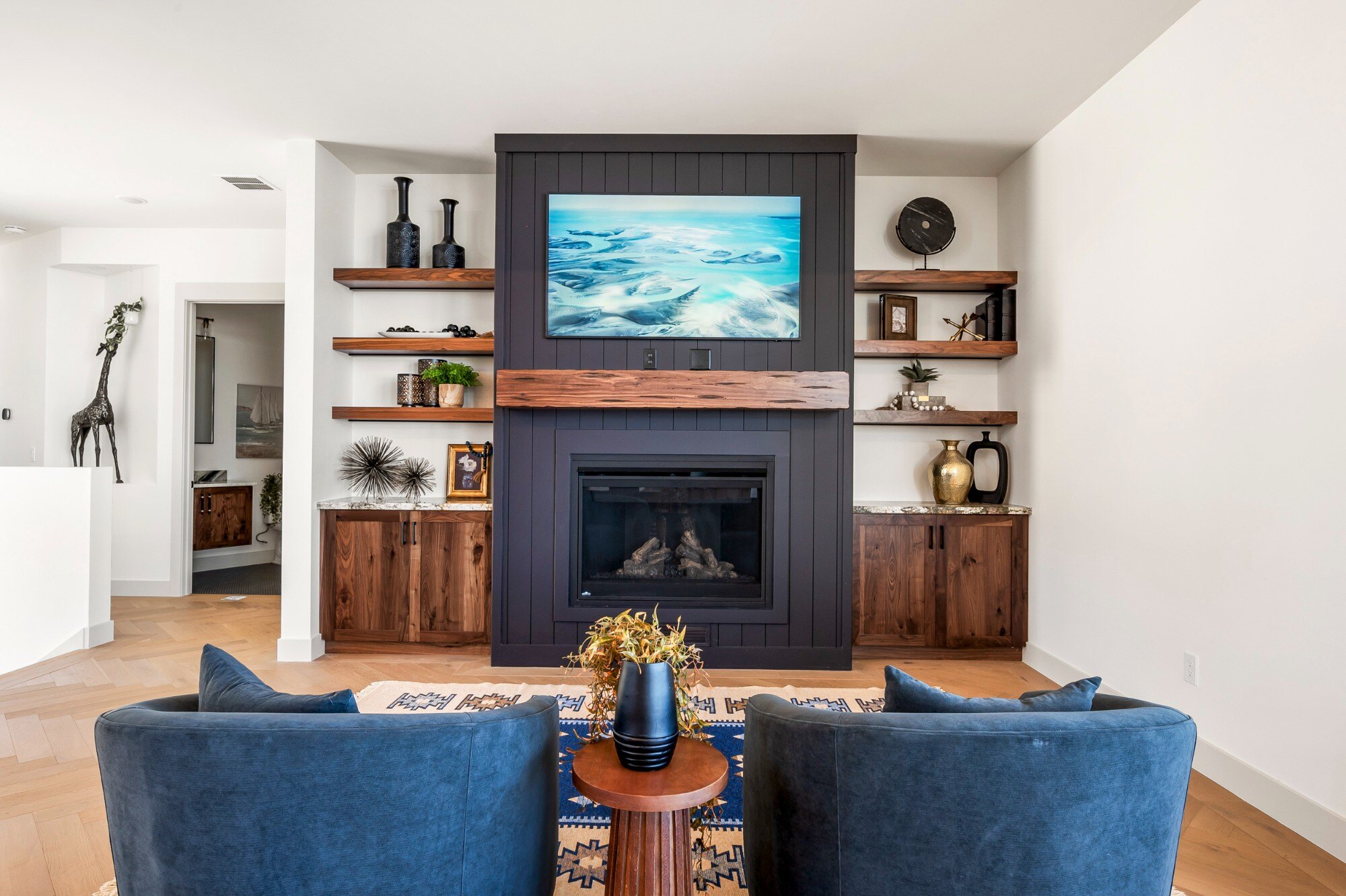 Cozy fireplace area with built-in shelving and contemporary decor in a custom mountain lodge home in Brian Head, UT by Choice Builders