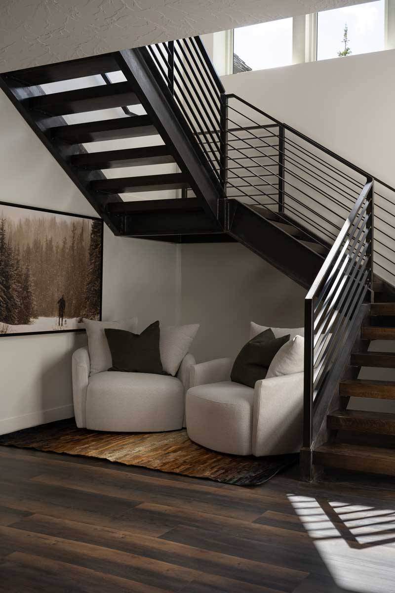 Cozy sitting area nestled around stairwell in custom home by Choice Builders in Cedar City, Utah