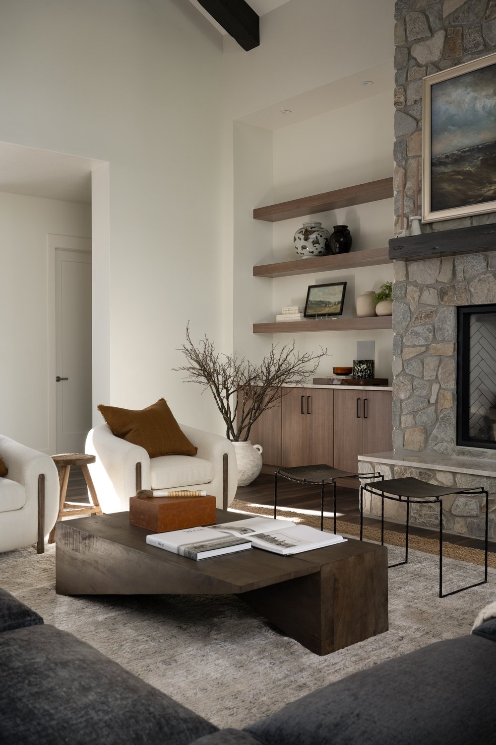 Custom home living room seating area by stone fireplace by Choice Builders in Brian Head, UT