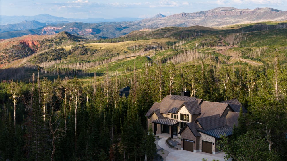 Aerial view of custom home in Brian Head, UT by Choice Builders among the mountains