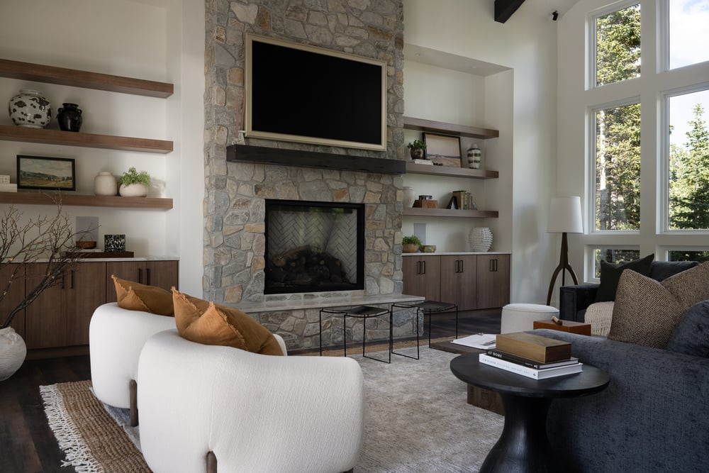 Living room area with stone fire place in custom home by Choice Builders in Brian Head, UT