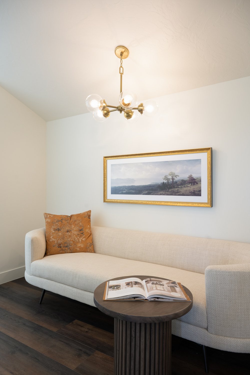 White couch under landscape painting in sitting room of custom home in Brian Head, UT by Choice Builders