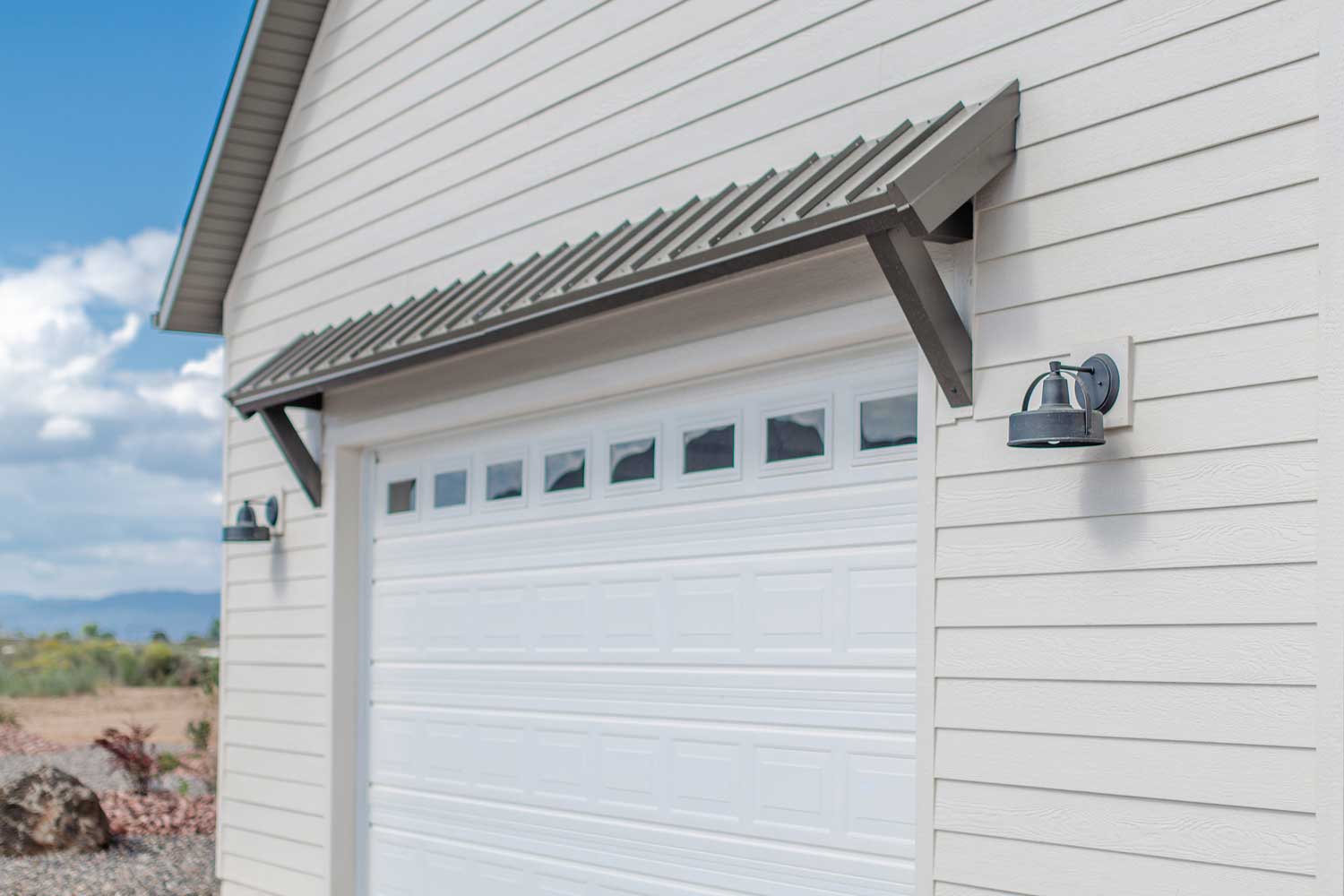 garage door with brown overhang and side lights