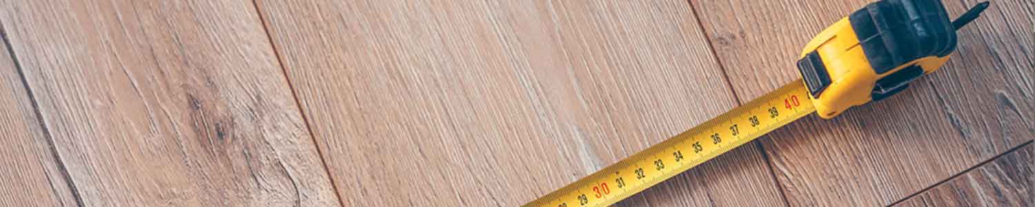 Measuring tape along wood flooring